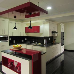 Supplied kitchen image with contrasting cabinetry and pendant lighting